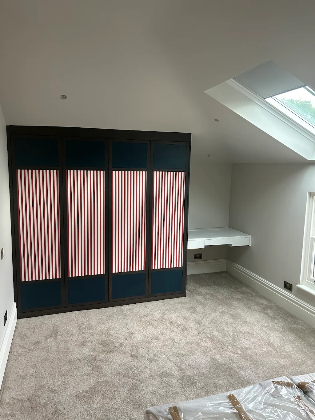 Modern attic room with fitted joinery and fresh paintwork