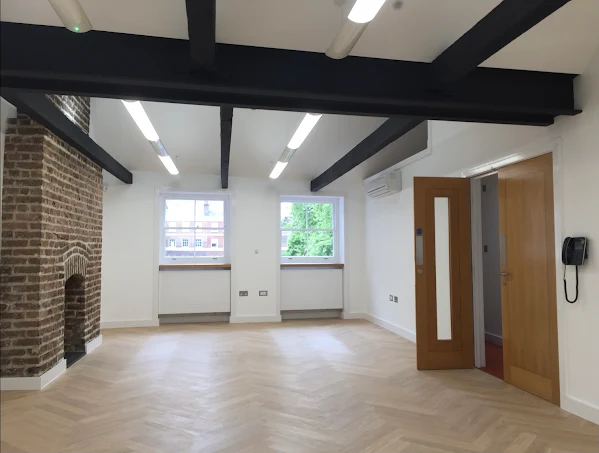 Refurbished interior with exposed beams and herringbone flooring