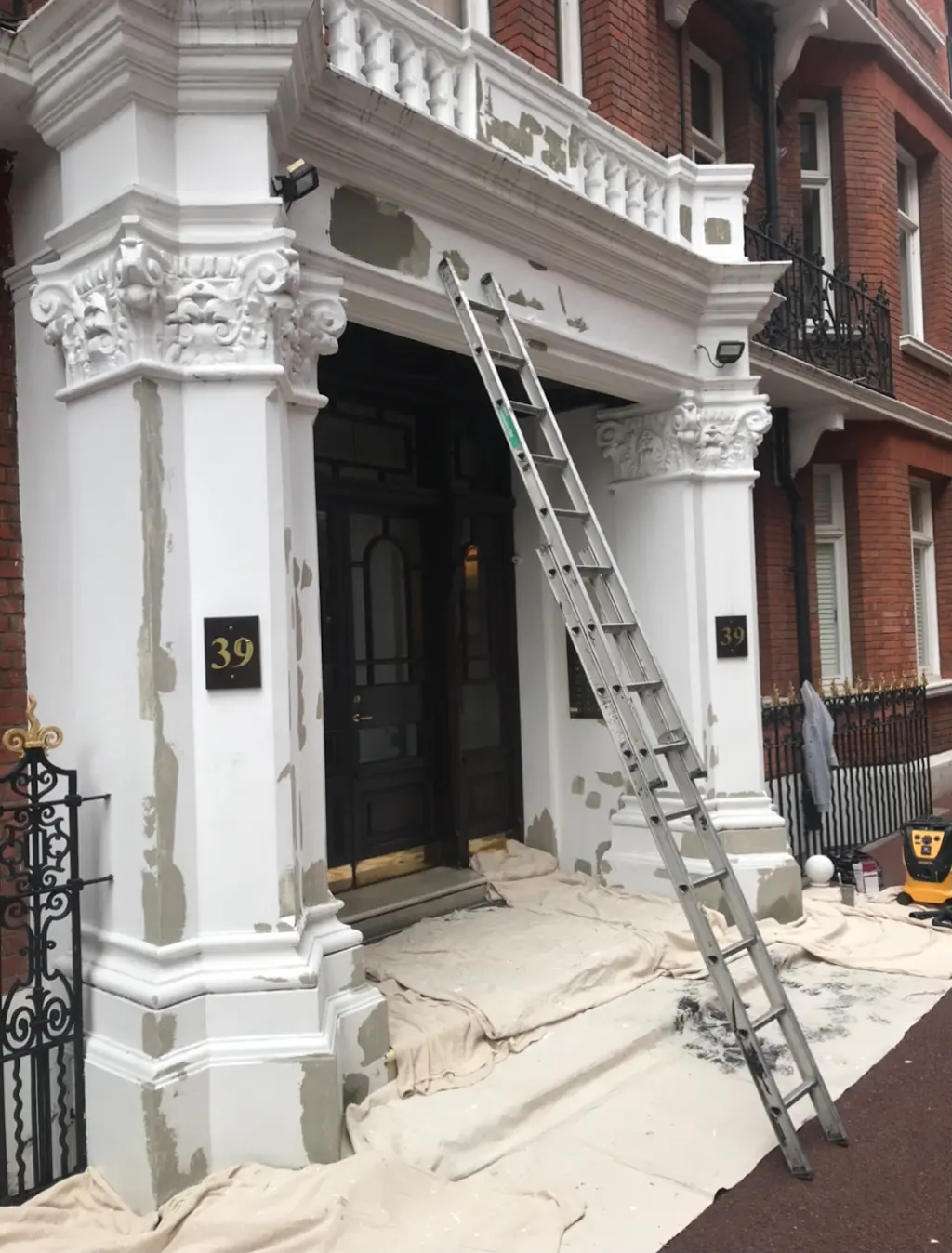 Exterior facade preparation and painting in progress